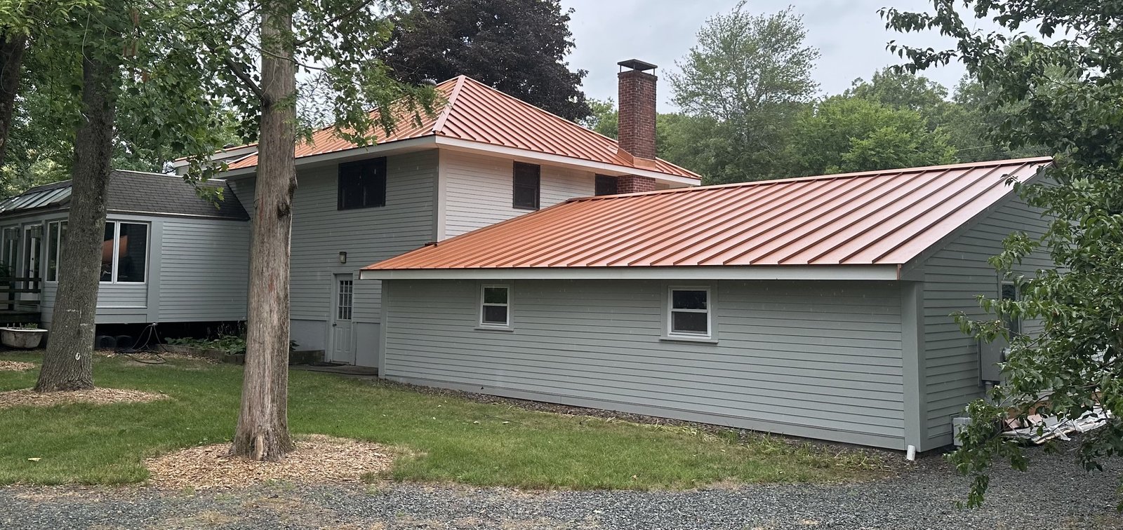 The addition and garage with the new copper roof